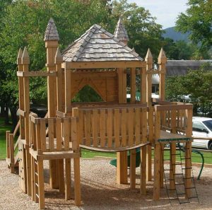 Castle themed playground mimics the church architecture - Asheville Playgrounds