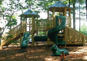 Playground with multiple slides, crawl tunnel, and bridge. Built for Audobon Apartments in Asheville, NC - Asheville Playgrounds