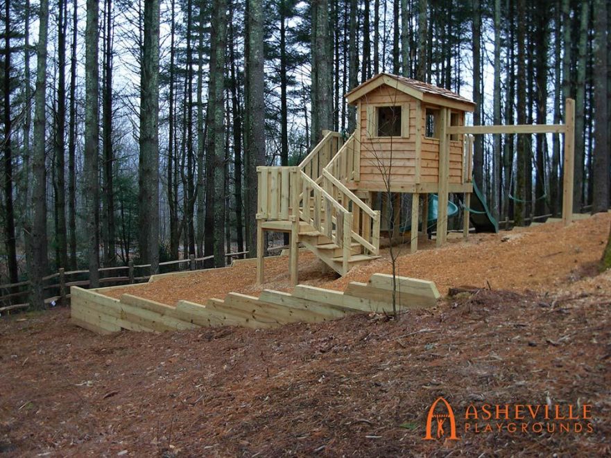 Wooden Playhouse on Hilly Backyard with Retaining Wall
