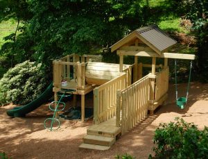 Steep sideyard playground with suspension bridge and crawl tunnel linking the decks - Asheville Playgrounds