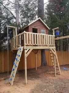 Tree deck and cabin with firepole, rock climbing wall, and swings - Asheville Playgrounds