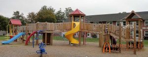 Large playground with bridges connecting all of the decks. Built for Hillcrest Apartments in Asheville, NC - Asheville Playgrounds